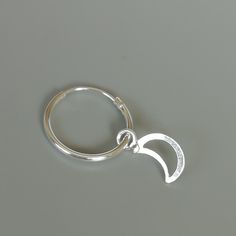 A PAIR of sterling silver hoops. Comes with a detachable cut out crescent moon charm. The charm is multipurpose and can be used with a neck or bracelet chain too. Dimension: Hoop- 15 x 1.5 mm Charm: 6 x 12 mm Drop length- 23 mm These earrings are made of 925 hypoallergenic sterling silver and plastic. Please note this price is for ONE PAIR. All my pieces are sent in a gift box. I can include a personal message from you if needed You are welcome to contact me at... bhavnakwintra1956@gmail.com For Crescent-shaped Single Huggie Earring As Gift, Crescent Single Huggie Earring As Gift, Crescent Shaped Single Huggie Earring Gift, Celestial Huggie Earrings With Moon Charm, Adjustable Moon Charm Hoop Earrings, Adjustable Hoop Earrings With Moon Charm, Celestial Small Hoop Earrings For Everyday, Celestial Small Hoop Huggie Earrings, Sterling Silver Celestial Earrings For Everyday