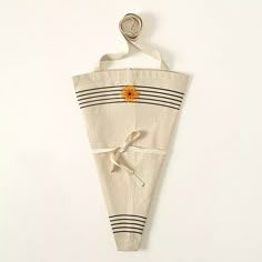 a piece of cloth with a flower on it hanging from a hook or hanger