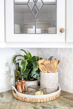 a basket with utensils sits on the counter