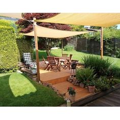 an outdoor patio with wooden decking and plants