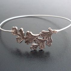 Oak Leaf Bracelet - Oak Leaf Jewelry - A collection of oak leaves in an antique silver tone finish has been transformed into a delicate oak leaf bangle bracelet with bangle band choice of silver filled or sterling silver. This oak tree jewelry also available in a gold tone finish with bangle band choice of brass or 14k gold filled for your oak bracelet. This oak bangle bracelet looks great stacked with others from my collection as you can see from the 4th pictures. Have fun stacking your oak tre Oak Leaf Ring, Oak Tree Jewelry, Oak Leaf Jewelry, Oak Jewelry, Oak Tree Tattoo, Leaves Ring, Silver Oak, The Bangles, Leaf Bracelet