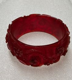 Red Translucent Floral Bakelite Bangle TESTED 2.04 oz. 2.59" I.D. 3.33" O.D. Red Intaglio Jewelry For Formal Occasions, Red Carved Jewelry For Wedding, Elegant Red Round Cuff Bracelet, Wedding Red Cuff Bracelet, Red Vintage Bangle For Wedding, Handmade Red Cuff Bracelet For Formal Occasions, Formal Red Handmade Cuff Bracelet, Formal Handmade Red Cuff Bracelet, Bakelite Bangles