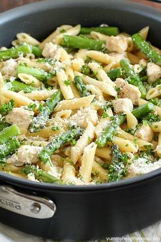 pasta with chicken, broccoli and parmesan cheese in a skillet