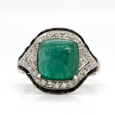 The Trinity ring is a handmade piece inspired by the Art Deco style that centers one natural sugarloaf cut emerald that weighs 3.80ctw. The center stone is surrounded by 30 old mine cut diamonds of H color and VS1 clarity that weigh 0.40ctw and 24 calibrated cut onyxes. Ring measurement: 18mm by 15mm by 9mm Ring size: 7 ½  Total weight: 5.9 grams/ 3.8dwt Art Deco Jewelry Rings, 9mm Ring, Doing The Right Thing, Trinity Ring, Platinum Diamond Rings, The Trinity, Platinum Ring, Art Deco Inspired, Art Deco Jewelry