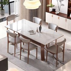 a dining room table with chairs around it