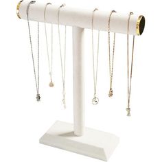 a white display stand with several necklaces on it's sides and two rings hanging from the top