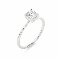 a white gold engagement ring with a single diamond in the center, on a white background