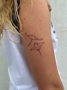 a woman's arm with a tattoo on it that has an image of a bird flying through the air