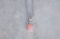 "Gorgeous pairing of a pink opal and CZ accent gemstone. The gemstones are handset into a sterling silver pendant and hung from a sterling silver chain. This pink opal has amazing flashes of color when it catches the light. The resulting necklace is stunning yet simple, a truly elegant necklace! The necklace ships in a lovely gift box ready to give as a gift or keep for yourself! Pictured with cubic zirconia accent stone color: \"White / Clear - April\" Setting Material - 925 Sterling Silver Cha Pink Opal Necklace, Opal Necklace Silver, Necklace Opal, Elegant Necklace, Gold Jewelry Indian, Cheap Jewelry, October Birthstone, 925 Sterling Silver Chain, Elegant Necklaces