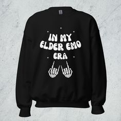 The In My Elder Emo Era unisex sweatshirt is perfect for anyone who grew up in the pop punk and emo scene and is still fully immersed in the culture today. Millennials are especially going to love this if they're still obsessed with emo, pop punk, or alternative music and culture. With a bold design and comfy fit, this sweatshirt is the perfect way to show that it was never a phase. Wear it to concerts, festivals, and more to keep you warm and looking cool.  The In My Elder Emo Era sweatshirt is Oversized Punk Sweatshirt With Letter Print, Black Punk Sweatshirt With Letter Print, Punk Style Letter Print Sweatshirt For Streetwear, Emo Graphic Print Sweatshirt For Winter, Black Grunge Sweatshirt With Letter Print, Winter Emo Crew Neck Sweatshirt, Emo Letter Print Sweatshirt For Streetwear, Punk Letter Print Sweatshirt For Fall, Punk Style Letter Print Sweatshirt For Fall