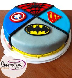 a birthday cake decorated to look like batman and superman symbols