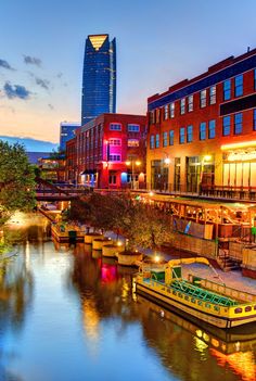 a river running through a city next to tall buildings