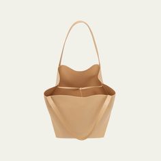 Mansur Gavriel tote bag in soft calf leather Flat shoulder straps  Open top with self-tie closure  Interior, leashed zip pouch bag Approx. 11.8"H x 21.5"W x 9"D Made in Italy Chic Leather Hobo Bag For Daily Use, Chic Daily Leather Hobo Bag, Everyday Double Handle Bucket Bag, Daily Double Handle Bucket Bag, Calf Leather Shoulder Bag With Double Handle For Everyday, Everyday Calf Leather Shoulder Bag With Double Handle, Calf Leather Shoulder Bag With Removable Pouch For Everyday, Everyday Calf Leather Shoulder Bag With Soft Leather, Everyday Calf Leather Shoulder Bag With Removable Pouch