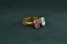 This ring is made with solid Sterling Silver (925 Silver), and has a 22K Gold-plating. A beautiful pink Tourmaline and a rough Pearl make this ring an ideal gift for any lady of any age. Pink Cabochon Ruby Ring Gift, Handmade Gold Tourmaline Ring, Handmade Tourmaline Gold Ring, Antique Pink Gemstone Rings, Vintage Tourmaline Rings As Gifts, Vintage Tourmaline Ring For Gift, Handmade Pink Amethyst Ring As Gift, Handmade Pink Amethyst Ring For Gift, Handmade Pink Amethyst Ring Gift