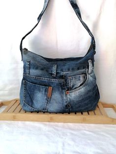 Sholder Denim bag Hobo Crossbody bag Gift For Her Casual Market Bag Shabb Upcycled Bag Recycle Denim Handbag Shoulder Purse Introducing our handcrafted jeans bag, an ideal blend of style, functionality, and sustainability. This eye-catching denim bag is not only a great fashion statement but also a step towards conscious consumerism. Made entirely from upcycled jeans, this bag is a testament to the fact that style and eco-friendliness can go hand in hand. A great gift for you or a friend. Measures from side to side when laid flat: Width 47 cm / 18 in Lenght 33 cm/ 13 in Deep: 12 cm / 5 in Handle: 86 cm / 34 in Pockets: 6 (3 inside,3 outside) Close bag with: metal zipper See more like this bag in my shop: https://www.etsy.com/shop/ArtAnnByBoutique?ref=profile_header Large Capacity Denim Crossbody Bag, Denim Crossbody Bags For Daily Use, Daily Use Denim Crossbody Bag, Denim Tote Shoulder Bag With Zipper Closure, Denim Travel Bag With Adjustable Strap, Travel Denim Bag With Adjustable Strap, Rectangular Denim Hobo Bag For Daily Use, Rectangular Denim Shoulder Bag With Zipper Closure, Denim Crossbody Shoulder Bag For Daily Use