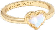 a gold ring with a heart shaped opal in the center and words on it