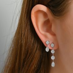 These pave drop earrings feature a circular and pear design encrusted with shimmering pave-set stones, creating a dazzling display of brilliance. Each stone is meticulously set to maximize its sparkle, covering the entire surface of the drops with a seamless, glittering effect. They will instantly capture attention with their timeless beauty and undeniable charm. Available in 14K White Gold Diamond weight = 0.23 carats Earring length = 14.30mm Diamond quality = GH-Color, SI-Clarity Dazzling Dangle Diamond Earrings With Pave Setting, Sparkling Diamond Drop Cluster Earrings, Teardrop Diamond Earrings With Sparkling Stones, Teardrop Diamond Bridal Earrings With Sparkling Stones, Sparkling Cluster Earrings For Formal Occasions, Drop Diamond Earrings With Pave Setting, Brilliant Cut Teardrop Diamond Earrings For Party, Sparkling Diamond Teardrop Bridal Earrings, Diamond Teardrop Earrings With Sparkling Stones