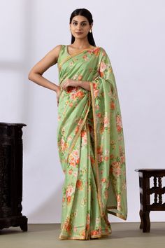 Pista green saree with floral digital prints and lace detailing. Paired with embroidered blouse.
Components: 2
Pattern: Printed, Embroidered
Type Of Work: Floral
Neckline: Round
Sleeve Type: Sleeveless
Fabric: Chanderi
Color: Green
Other Details: 
Lace detailing
Back tassel tie-up
Occasion: Puja - Aza Fashions Bollywood Style Digital Print Pre-draped Saree For Diwali, Green Pre-draped Saree With Sheer Dupatta For Eid, Green Pre-draped Saree With Printed Motifs, Green Fitted Pre-draped Saree For Summer, Summer Chanderi Pre-draped Saree With Traditional Drape, Summer Chanderi Pre-draped Saree, Designer Digital Print Saree For Eid, Green Pre-draped Saree With Dupatta, Green Pre-draped Saree With Sheer Dupatta For Diwali