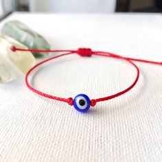 Handmade Bracelet W/ Red Waxed Polyester Thread Ft. A Dainty, Lucky Blue Evil Eye Glass Bead. Finished With A Secure Closure Knot! : Adjustable! (Fits 5“ To 8.5 In. Wrist) M E A N I N G : The Evil Eye (Nazar) Serves As A Protection Against Evil Stares, Negativity & Envy From Others. | The Red String (Kabbalah) Symbolizes Good Luck And Protection ! #: Handmade Stackable Bracelet Gypsy Bohemian Hippie Kabbalah Dainty Jewelry Minimalist Style Surfer Beach Gothic Witchy Wicca Kawaii Coconut Girl Gra Red Round Beads Bracelet For Everyday, Everyday Red Friendship Bracelet With Round Beads, Red Minimalist Beaded Bracelets For Everyday, Minimalist Red Beaded Bracelets For Everyday, Red Adjustable Bracelets For Everyday, Minimalist Red Beaded Bracelets As Gift, Adjustable Red Bracelets For Everyday, Minimalist Red Round Bead Bracelets, Dainty Adjustable Red Bracelet