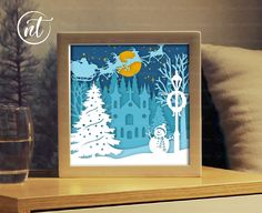 a paper cut christmas scene with santa and his sleigh