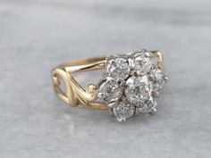 an antique diamond cluster ring in yellow gold