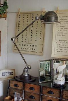 an old fashioned desk lamp sitting on top of a dresser