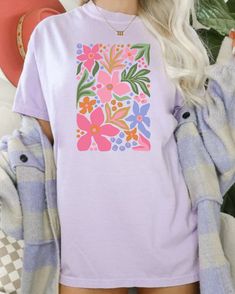 Spring Purple T-shirt With Graphic Print, Pink Graphic Tee With Plant Print, Pink Graphic Tee With Plants Print, Spring Purple Printed T-shirt, Multicolor Crew Neck T-shirt With Plant Print, Multicolor Floral Print Crew Neck T-shirt, Pink T-shirt With Plants Print In Relaxed Fit, Lavender Graphic Print Tops For Summer, Lavender Tops With Graphic Print For Summer