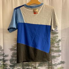 a blue and grey shirt hanging on a wall