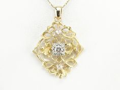 Stunningly ornate and wonderfully one of a kind, this pendant was created right here in our New Hampshire studio from vintage and components! A large yellow gold piece with ivy like filigree has been set with Retro Era 1950's white gold place cards centered with glittering diamonds! The use of the yellow and white metal make this the perfect piece to wear with any metal, and the size and style make it a classic wardrobe staple! This pendant does not come with the chain shown. Please feel free to Luxury Filigree Diamond Pendant Necklace, Gold Place Cards, Retro Era, Snowflake Pendant, Three Stone Diamond, Classic Wardrobe Staples, Filigree Pendant, Cameo Ring, Diamond Glitter