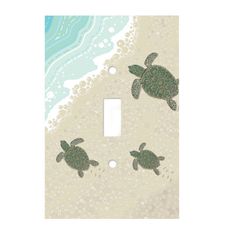 a light switch cover with sea turtles on the beach