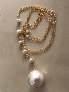 "This necklace is made with a Kasumi-like pearl as the focal, also known as an Edison pearl, which is a type of freshwater pearl known for its lovely textured, slightly uneven surface that yields an amazingly high luster. It's breathtaking in sight and size - 14-15mm. This gold-filled Y-necklace is meant to wear long, preferably with shorter necklaces to complement layering. The length is 20\" with a 2.5\" extender chain, but the length can be modified if desired to be shorter. Five small nugget Long Baroque Pearl Necklace With Pearl Drop, White Baroque Pearl Lariat Necklace, Long Baroque Pearl Drop Necklace, Akoya Pearl Teardrop Necklace With Pearl Chain, Teardrop Akoya Pearl Necklace With Pearl Chain, White Pearl Drop Lariat Necklace, White Lariat Pearl Necklace With Pearl Drop, Hammered Pearl Jewelry Gift, Akoya Pearl Teardrop Necklace