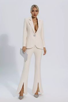 The first choice for urban women's professional wear is our new product Mallory Ivory White Long Sleeve Blazer Set. The upper body of the suit is a long-sleeved V-neck blazer decorated with diamond buttons. The lower body is slightly slit bell-bottom pants with an invisible zipper design and heart-shaped cloth buttons—well-cut and graceful curves. Whether for everyday wear or attending a party, this set is a standout!  Top Length: Approx 68cm Pants Length: Approx 112cm Materials: Polyester Outfit Grado, Cloth Buttons, Glitter Wedding Dress, Bandage Midi Dress, Professional Wear, Blazer Set, Floral Shirt Dress, Travel Party, Puff Sleeve Dresses