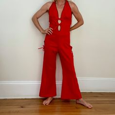 Vintage 70s red polyester cutout jumpsuit by Frederick's of Hollywood. A little big on me in underbust area. Straps make the torso length adjustable. Minor spot and area of piling. Overall great condition. Has a few inches of stretch.  Under bust 32 Waist 30 Hip 40 Inseam 26 70s Disco Fashion, 70s Romper, 70s Fashion Disco, 70s Jumpsuit, Disco Jumpsuit, Cutout Jumpsuit, Disco Fashion, Fashion 70s, Womens Jumpsuits