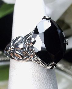 Black Cubic Zirconia (CZ) Ring Floral Leaf Design#127 Custom Made This is a stunning Art Nouveau reproduction in sterling silver filigree set with a 7ct marquise cut black/onyx Cubic Zirconia (CZ) gemstone. The black CZ is 16mm in long North South by 12mm wide, the ring sits 8mm off the finger. The inside of the band is marked 925 for sterling. Notice the beautiful craftsmanship of the silver floral filigree setting and band. This is a ornate and detailed filigree ring. A ring box is included an Swiss Blue Topaz Ring, Onyx Engagement Ring, Black Stone Ring, Black Gems, Filigree Jewelry, Pendants Necklaces, Gothic Rings, Deco Art, Retro Jewelry