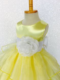 Beautiful organza ruffled dress tailor-made and ready to impress at any upscale event! Handcrafted with the upmost of care and attention to detail, we make sure that each dress is perfectly one of a kind for your little girl. Bridal satin top followed by a satin sash for a nice and snug fit Comes with a flower and matching colored sash. The skirt has layers of cut organza strips which are sewn onto the lining to create the ruffled effect The organza is then sewn at the edges to create those cris Sleeveless Satin Princess Wedding Dress, Spring Wedding Princess Dress With Bow, Fitted Satin Princess Dress For Wedding, Fitted Princess Wedding Dress With Bow, Fitted Wedding Princess Dress With Bow, Fitted Princess Dress With Satin Bow For Bridesmaids, Fitted Tulle Dress With Sashes, Formal Fitted Princess Dress With Bow, Organza Wedding Dress With Bow Detail