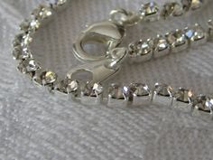 "Here we have a vintage rhinestone in silver metal costume jewelry bracelet. This is a very narrow 1/8\" prong set and 7\". These are a vintage item, please look at pictures. PLEASE convo me with any questions. Please check out my other items. Thanks for looking, Elvira" Silver Metal Tennis Bracelet For Formal Occasions, Formal Silver Metal Tennis Bracelet, Silver Crystal Bracelet Costume Jewelry For Gift, Silver Costume Jewelry Crystal Bracelet Gift, Silver Crystal Bracelet For Gift, Costume Jewelry Style, Silver Crystal Bracelet For Gift, Silver Costume Jewelry Crystal Bracelet For Wedding, Silver Crystal Bracelet With Rhinestones For Formal Occasions, Formal Silver Crystal Bracelet With Rhinestones