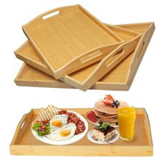 three wooden trays with breakfast foods on them