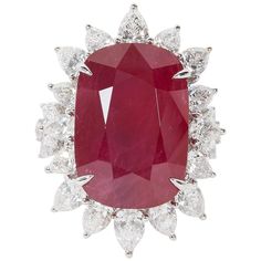 A rare find! Certified 24.64 carat cushion cut African Ruby with "intense red" color. The ruby is surrounded by 4.57 carats of pear shape diamonds. 18k Approximately 1.30 inches from its highest to lowest point, an inch wide. The ring is currently a size 7 but can easily be resized. Certified by C Dunaigre of Switzerland. A beautiful ruby ring! Antique Ruby Ring, Ruby And Diamond Ring, Vintage Cocktail Ring, Woman Jewelry, Ruby Diamond Rings, Ruby Pendant, Diamond Cocktail Rings, Ruby Jewelry, Vintage Cocktail