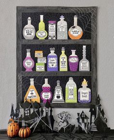 a shelf with halloween decorations and bottles on it