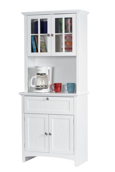 a white cabinet with glass doors and drawers on it's front door, next to a coffee maker