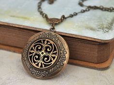 THE ETERNAL KNOT Celtic knot locket necklace in by plasticouture, $26.50 Antique Brass Pendant Locket Necklace, Bronze Brass Locket Necklace With Antique Finish, Bronze Pendant Locket Necklace With Antique Finish, Nickel-free Bronze Brass Locket Necklace, Bronze Antique Locket Necklace, Bronze Antique Finish Locket Pendant Necklace, Bronze Antique Finish Locket Necklace In Brass, Bohemian Antique Gold Brass Locket Necklace, Bronze Antique Finish Locket Necklace