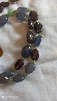 Vintage 340 Carat Fine Quality Natural Iolite, Garnet Multi Gemstone Beads Smooth Oval Shape 30 Inch With Pendent Necklace Stone :Natural Iolite, Garnet Multi Gemstone Shape :- fancy oval Necklace - 30 inch 1 line string Size :- 7x10mm to 12x16mm Weight :- 340 carat Polish :- Handmade Purity :- 100% Natural Gemstone color -brown,red,gray makes a great gift for your loved ones. Click below to see live stock: https://www.etsy.com/au/shop/ShakugemsStore?ref=search_shop_redirect If for any reason yo Oval Natural Stone Beads For Gifts, Natural Oval Beads Gemstones For Jewelry Making, Natural Stone Oval Beads For Jewelry Making, Oval Stones For Jewelry Making, Oval Natural Stones For Jewelry Making, Spiritual Oval Beaded Necklace With Gemstone Beads, Carnelian Bracelet, Oval Necklace, Necklace Stone