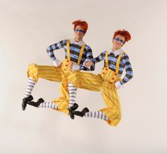 two men dressed in yellow and blue striped outfits, one with red hair and the other wearing white socks