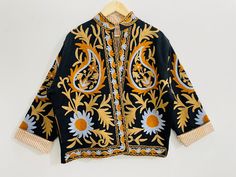 Experience the ultimate blend of luxury and bohemian style with our Suzani Hand-Embroidered Boho Jacket in vibrant Black/ Beige hues. This exquisite piece, meticulously handcrafted, features intricate Suzani embroidery that radiates elegance and artistic charm. Made from premium Cotton canvas, this jacket is designed to provide both warmth and style, making it the perfect addition to your winter wardrobe. Ideal for both men and women, this versatile jacket is not just a piece of clothing but a s Style Mantel, Suzani Embroidery, Embroidered Coat, Versatile Jacket, Boho Jacket, Style Coat, Coat Winter, Canvas Designs, Embroidered Jacket