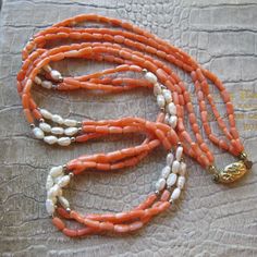 Asian Freshwater Pearls & Coral Bead Necklace, Gilt Vermeil Silver Traditional Asian Chinese Oval Ornate Clasp, 1960's to 1970's Eastern (far) Coral Gem Necklace. Drape or twist for varying style looks. The spacer tiny beads are silver, material unknown.  Length: 25 1/2 IN  Bead Width: Corals 3 MM, Pearls 4 MM, approx, they are longer than wide True Vintage  Condition is overall good, no major issues, original stringing (wear with care), gilt silver aka vermeil, clasp has some gold fade on rever Traditional Luxury Red Coral Beaded Necklaces, Luxury Coral Beaded Necklaces With Round Beads, Vintage Multi-strand Gemstone Bead Necklaces, Vintage Multi-strand Gemstone Beads Necklace, Vintage Multi-strand Gemstone Beads Jewelry, Vintage Double Strand Gemstone Bead Jewelry, Vintage Orange Oval Beads Jewelry, Vintage Double Strand Gemstone Beads Necklace, Vintage Coral Round Bead Jewelry