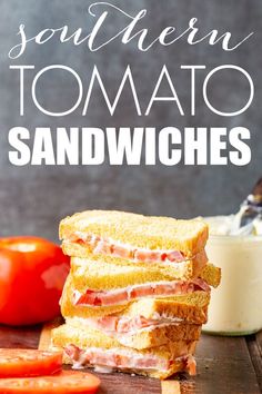 two sandwiches stacked on top of each other with tomatoes and mayonnaise in the background