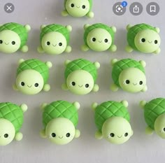 there are many green teddy bears made to look like pineapples on the table