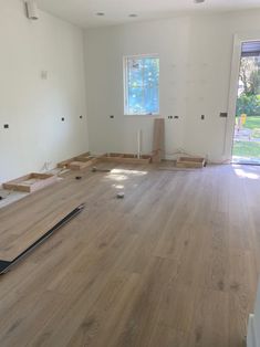 an empty room with hard wood flooring being installed