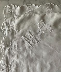 an embroidered tablecloth on a marble surface