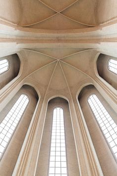 the interior of a cathedral with high vaulted ceilings and arched windows on either side of the ceiling